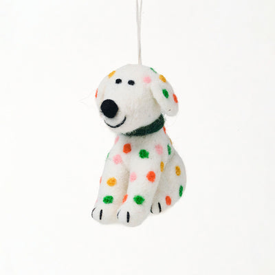 hanging christmas decoration shaped like a white dog with colourful spots in green, orange, pink and yellow.