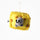 A yellow felt cheese-shaped ornament with brown spots and a gray felt mouse character in the center, hanging from a thin string against a plain white background.