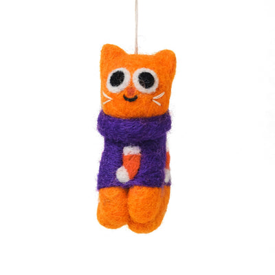 A felt cat ornament hanging by a thin string, with an orange body, purple scarf, and white and black facial details, shown on a plain white background.